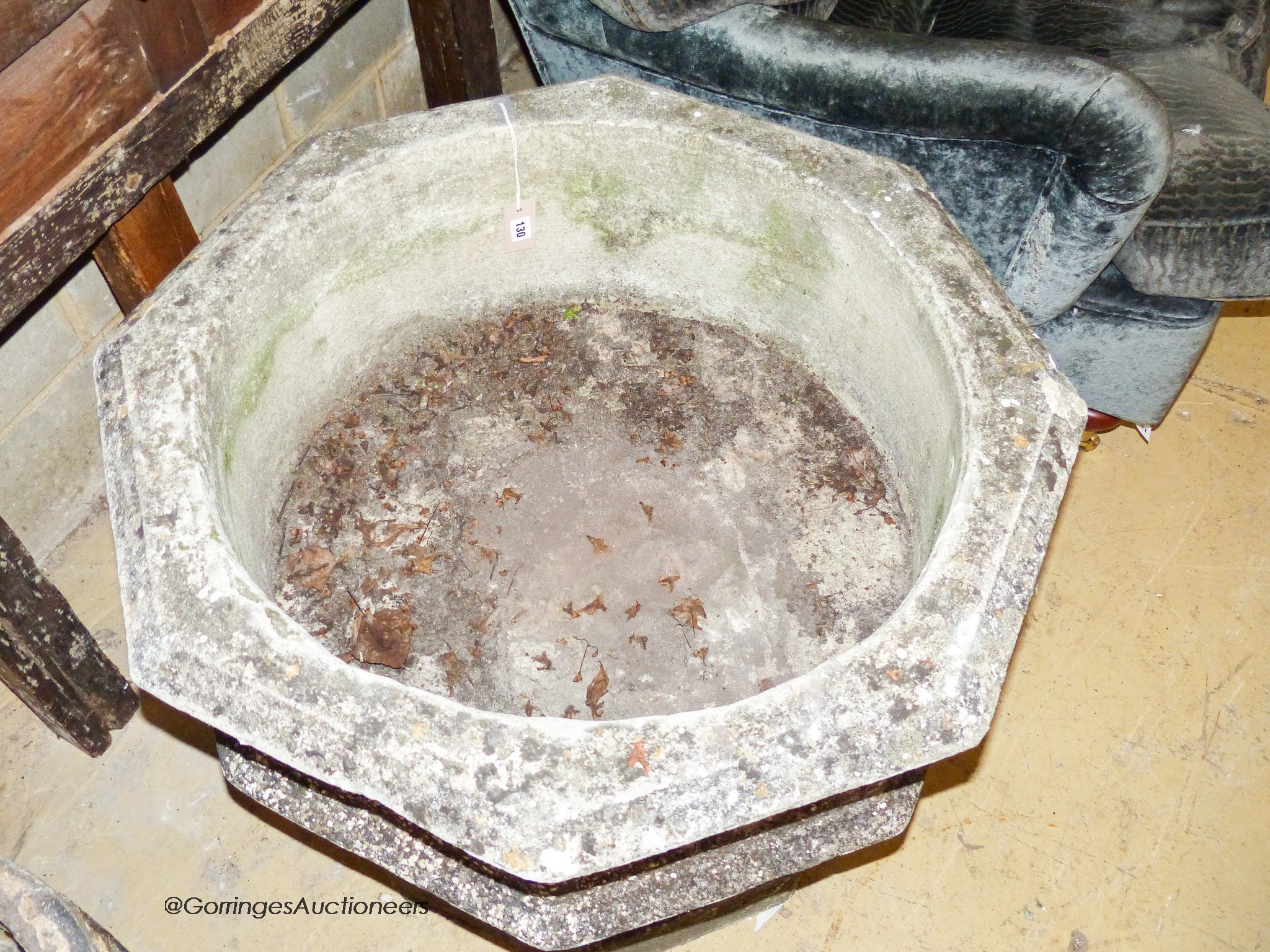 A large weathered Victorian octagonal carved stone font, width 80cm, height 67cm